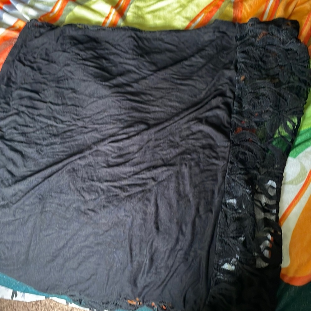 Black T-shirt with lace front and neck lace in the back.
